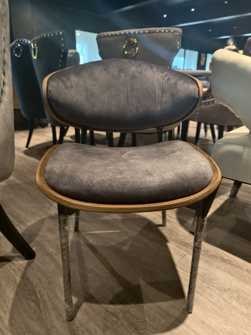 Gray upholstered chair with wooden frame