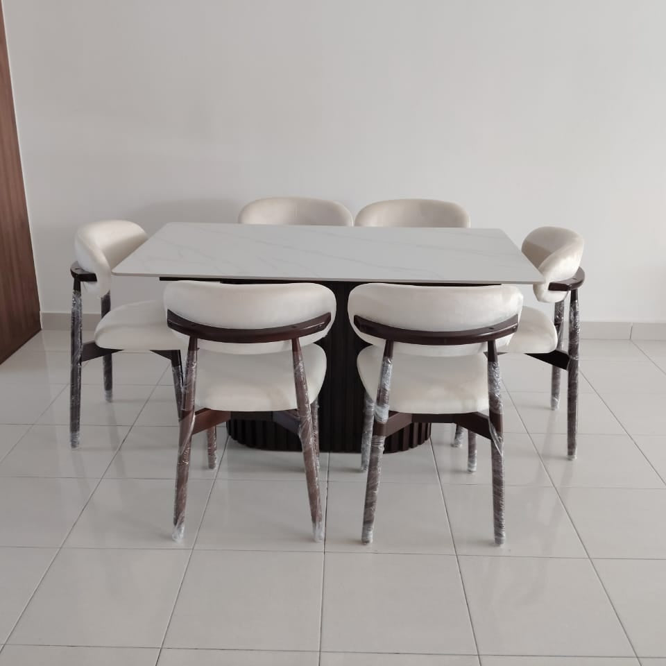 A modern dining set consisting of a rectangular white table and six chairs with white upholstered seats and backs, dark wood-look frames, and weathered silver metal legs, shown in a minimalist room with white tiled floors and a white wall.