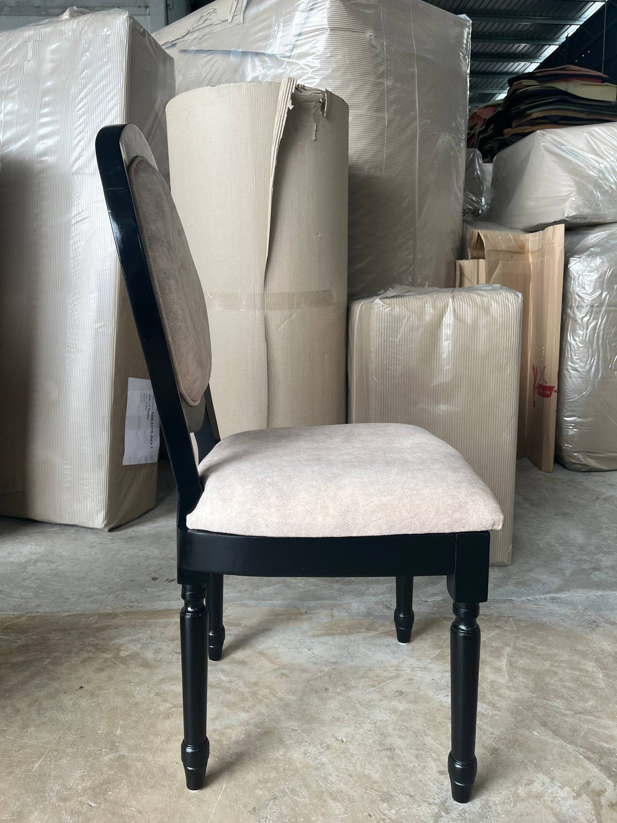 Side warehouse view of a cream Roma dining chair