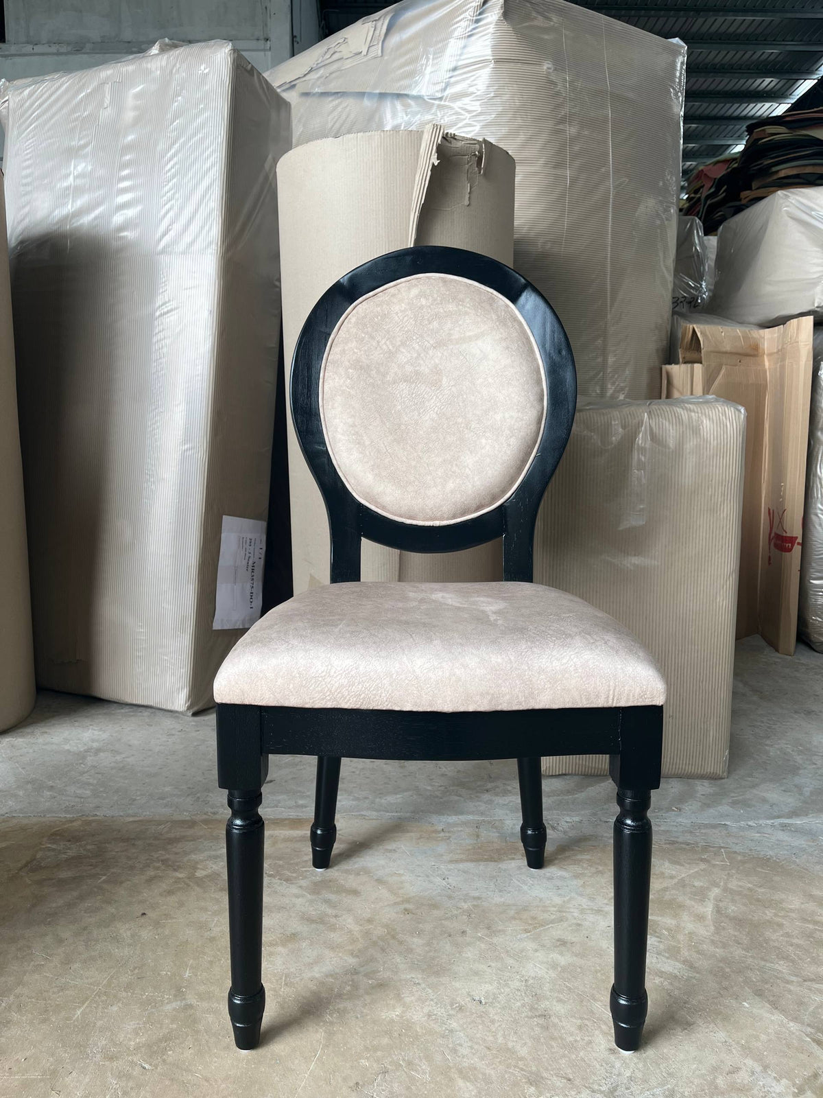 Front warehouse view of a cream Roma chair with a dark oval frame